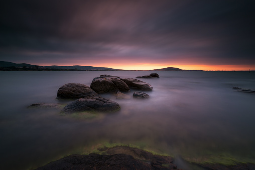 An image of sea sunrise, near the rocks