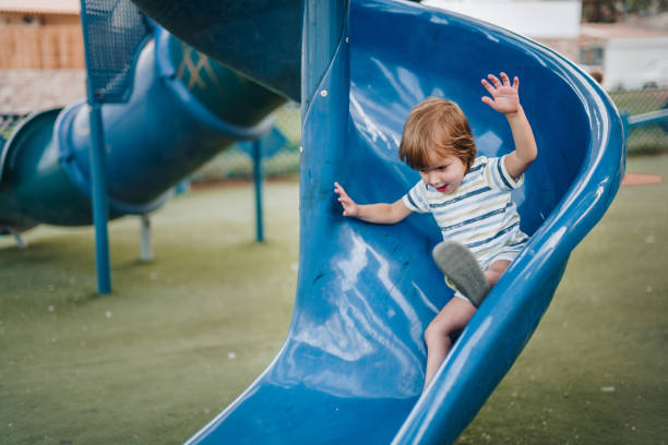 istock Carefree kid having fun while sliding on the playground. 1079553680