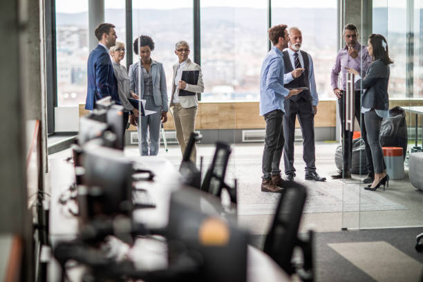 istock Large group of business colleagues communicating in a hallway. 1079556224