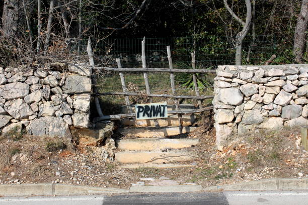 istock Abandoned garden with private sign on entrance 1079561096