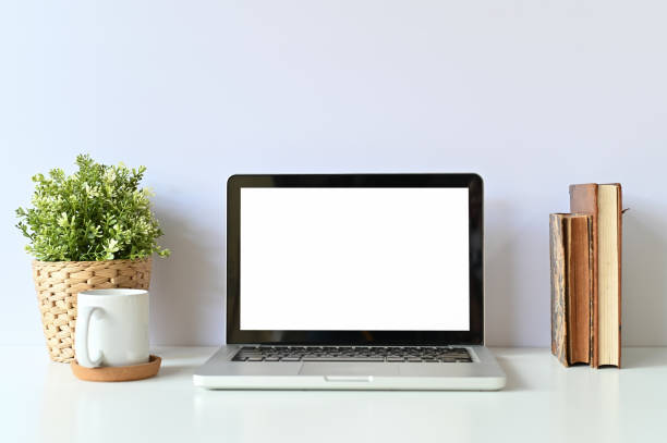 istock Mockup laptop computer, books, coffee and plant decoration on office table. 1079561336
