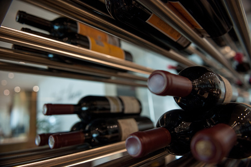 Close-up of wine bottles on shelfs