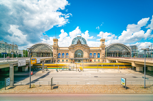 Dresden, Germany - July 3, 2016: Dresden  view showing Dresden Hauptbahnhof Central Station, Trams, buildings and statue with people on the background