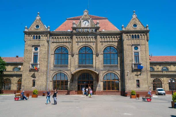 Arad, Romania - July 8, 2016: Arad  view showing railway stations building, flags, car and people passing by can be seen on the background