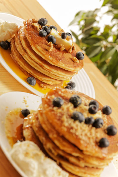 istock Wooden table with pancakes on a white plate 1079565918