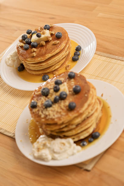 istock Wooden table with pancakes on a white plate 1079566174