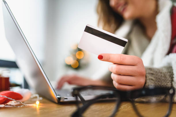 istock Young woman buying online at home  for winter holidays using laptop computer 1079573744