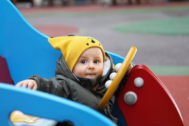 istock Baby With A Funny Yellow Hat And A Winter Jacket 1079574030
