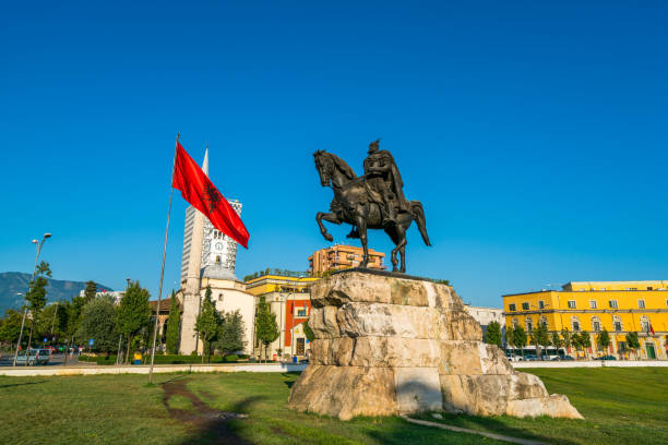The Main Square/ Skanderbeg square of Tirana and the Statue of Skanderbeg, Tirana, Albania, Europe Tirana, Albania - July 22, 2016:   view showing The Main Square or  Skanderbeg square of Tirana and the Statue of Skanderbeg , towers, buildings, flag, buses, street cars and people can be seen on the background tirana photos stock pictures, royalty-free photos & images