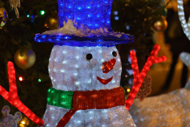 istock Snow man figurine and Christmas tree image 1079577418