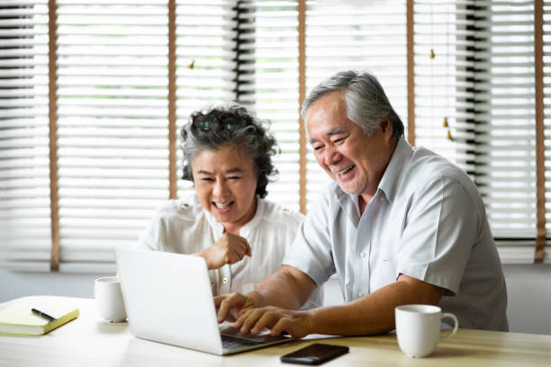 istock Relaxing Asian Senior Couple having fun with laptop computer. 1079595336