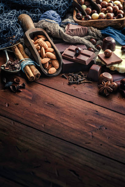 istock Chocolate, nuts and ingredients in old-fashioned style on wood table 1079595542