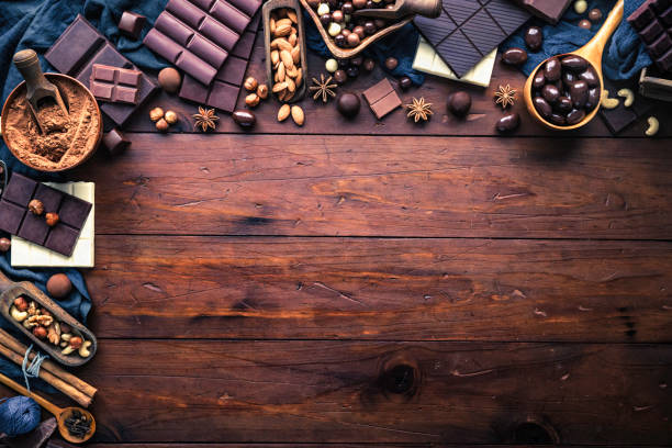 istock Chocolate, nuts and ingredients in old-fashioned style making a frame with copy space 1079595868