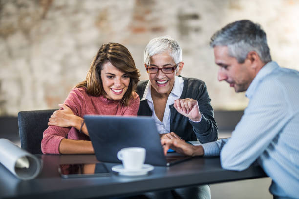 happy mother and daughter using laptop with real estate agent. - family insurance agent real estate financial advisor imagens e fotografias de stock