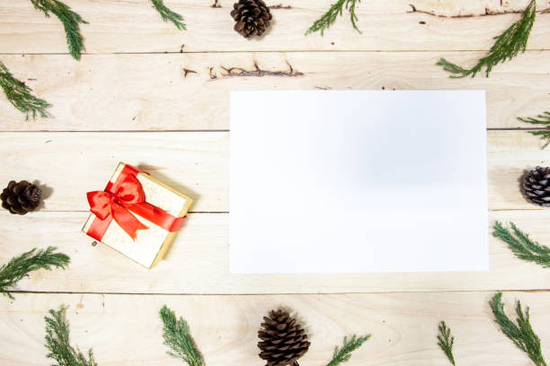istock Christmas Frame with paper on wooden background 1079599542