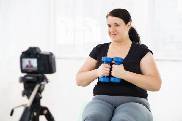 istock overweight blogger recording content for vlog 1079604042