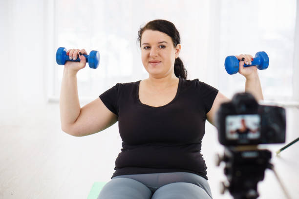 istock overweight blogger recording content for vlog 1079604044