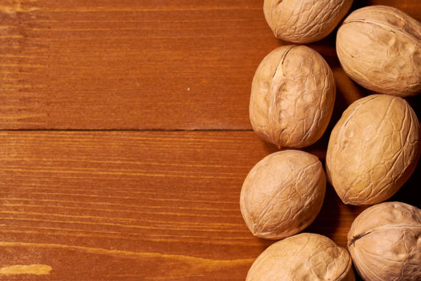 istock Walnut on brown wooden background. Selective focus. Copy space 1079605104