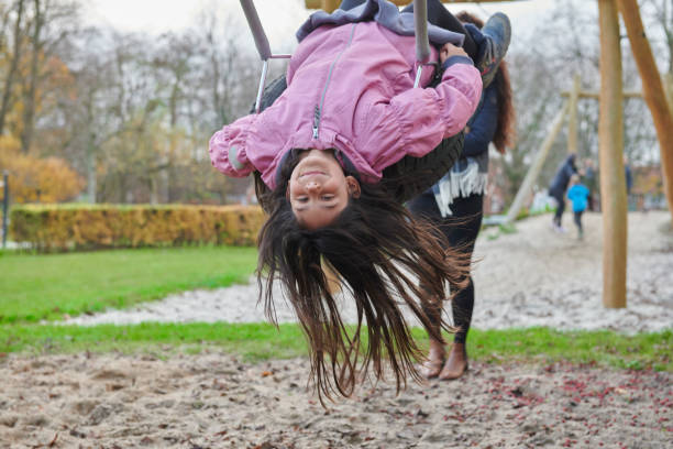 istock Single mother with girl on playground 1079607382