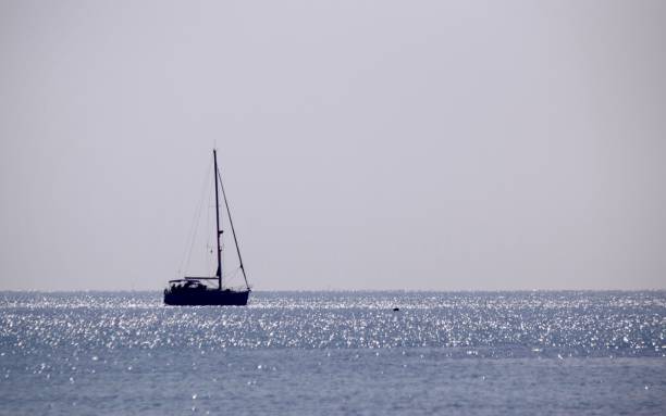 istock Sailing yacht silhouette in open sea. 1079610868