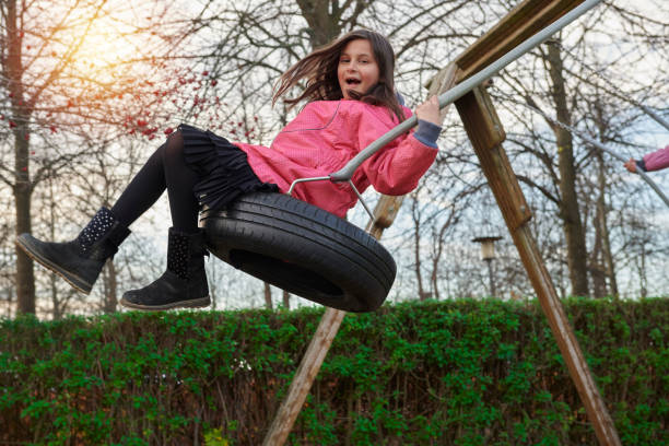 Pakistan immigrants in Denmark. Girl having fun at the playground swinging.