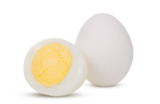 istock Two boiled whole and sliced eggs isolated on white background 1079621516