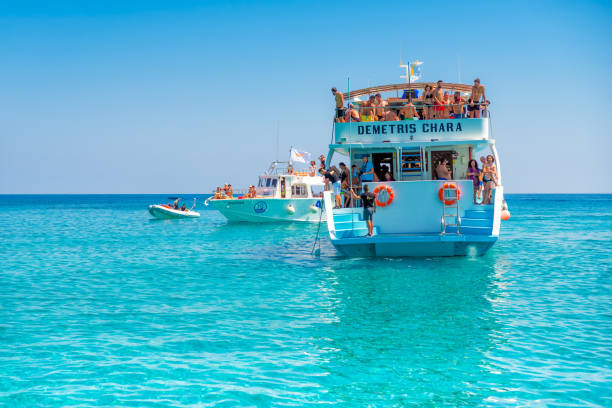 AYIA NAPA, CYPRUS - JULY 23, 2017: A boat with tourists sails along the coast.