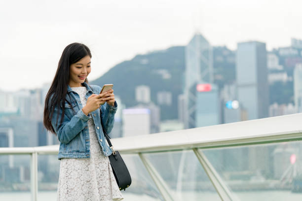 istock Young woman using her smartphone outdoors 1079626204