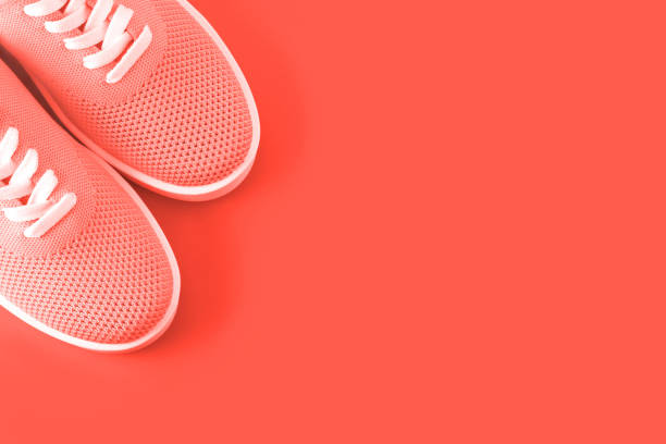 istock Bright orange sneakers on an orange background. 1079630198