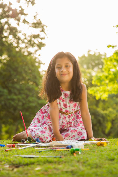 istock girl drawing during spring day in nature. - Stock image 1079634110