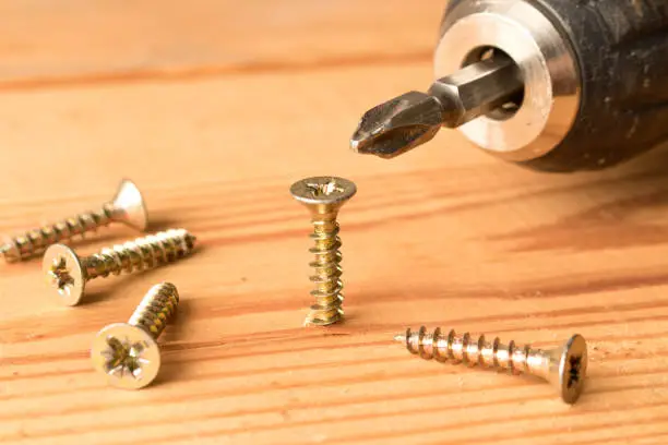 Photo of Screwdrivers and screws on a wooden table. The concept of work. Labor day