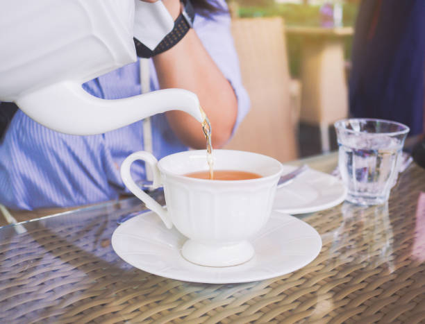istock Woman pouring tea 1079643386