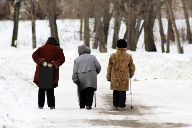 istock Three elderly women walking along the Avenue in winter 1079643986