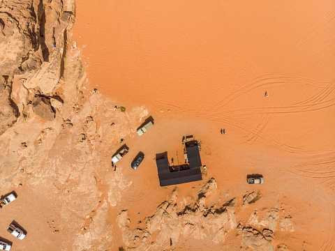 Vertical aerial photograph of a Bedouin tent and parked SUV in the desert nature reserve Wadi Rum, Jordan, taken with the drone from above