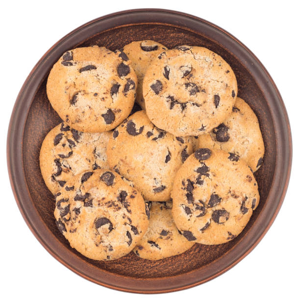 istock Cookies with chocolate in a brown plate. Isolated on white background. Top view. 1079648768
