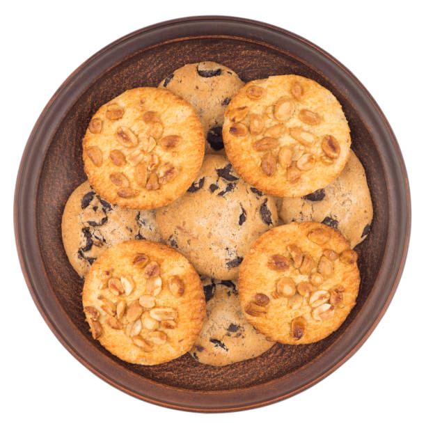istock Cookies with peanuts and chocolate in a brown plate. Isolated on white background. Top view. 1079649102