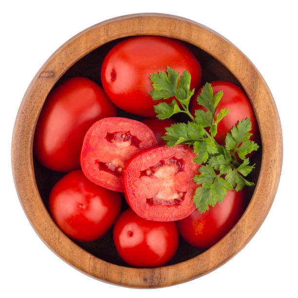 Fresh tomatoes in wood bowl on white background. Top view.