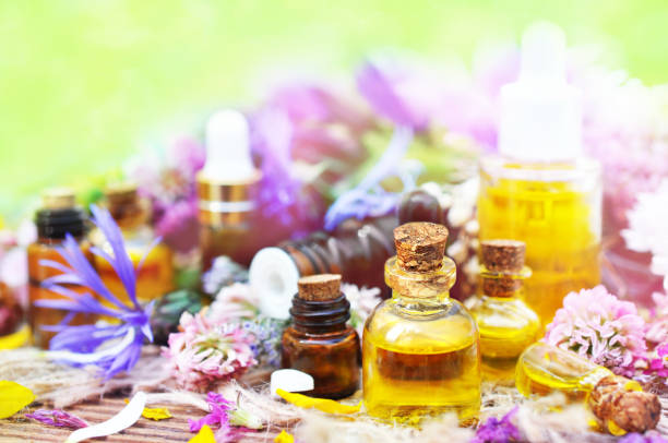 istock Essential oils on medicinal flowers and herbs background 1079655274