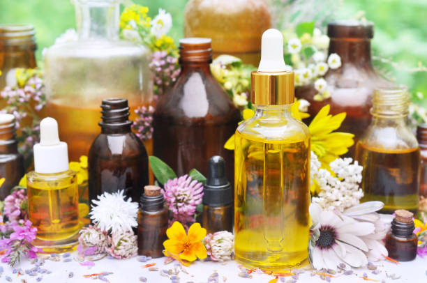 istock Essential oils on medicinal flowers and herbs background 1079656110