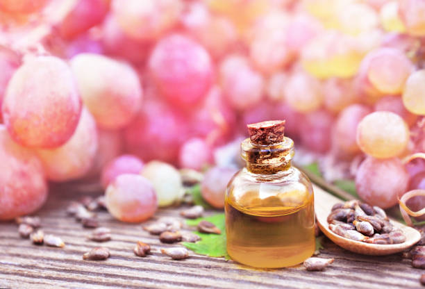 istock Essential oil on red grape fruits and stones background 1079657952