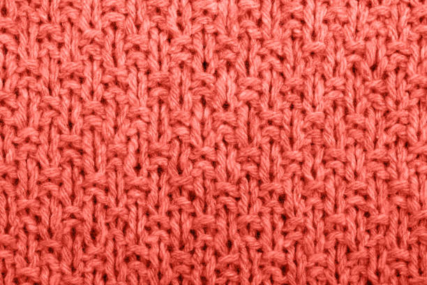 istock Knitted fabric texture living coral color. 1079658044