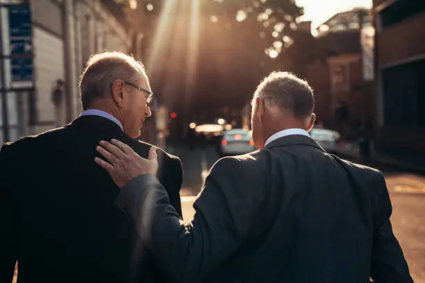 Photo of Senior businessman walking together outdoors