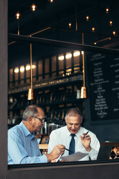 istock Two senior men having business meeting in a pub 1079658974
