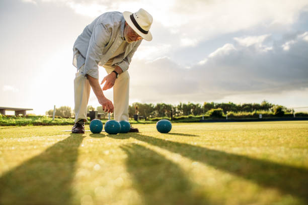 istock Old man picking a boules standing in a lawn 1079669002