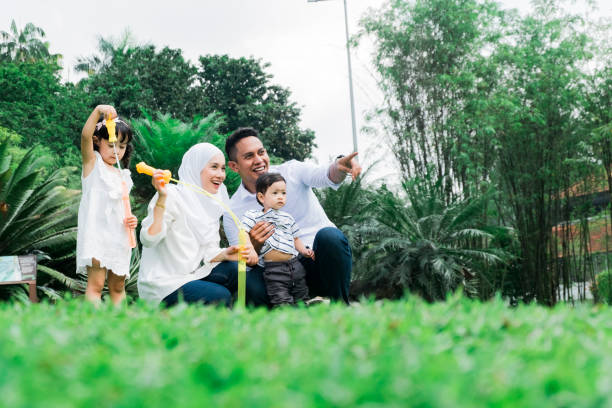 happy family concept with enjoying expression face, having fun at public park.