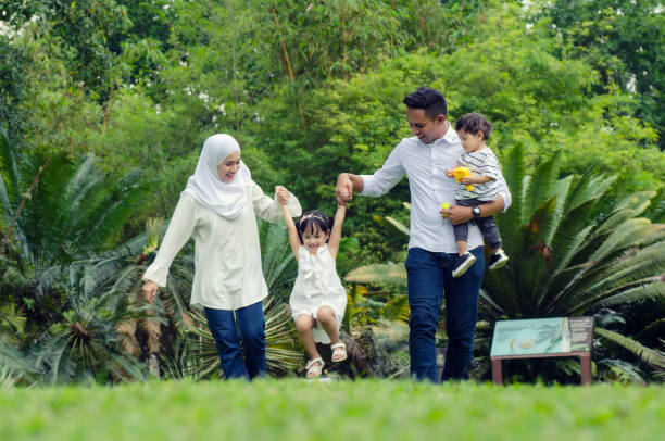 istock happy family concept with enjoying expression face,having fun at public park. 1079669730