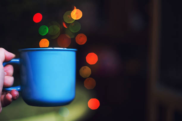 a cup in the hand . Christmas bokeha cup in the hand . Christmas bokeha cup in the hand . Christmas bokeh