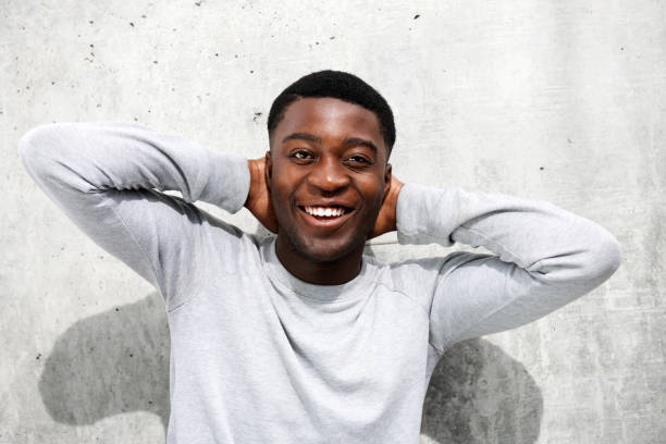 istock Close up happy young black man smiling with hands behind head 1079671150