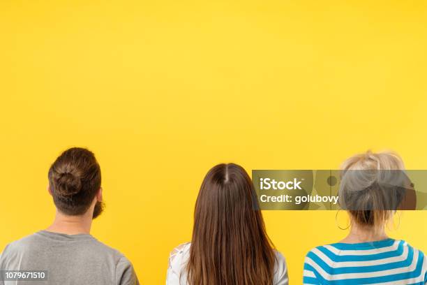 Back View People Standing Yellow Background Stock Photo - Download Image Now - People, Rear View, Contemplation