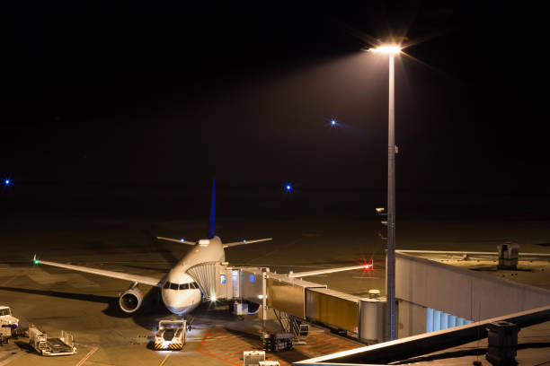 istock an airplane at night at an airport gate 1079672908